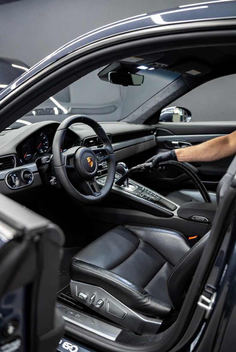 Vacuuming a Porsche interior during deep interior restoration